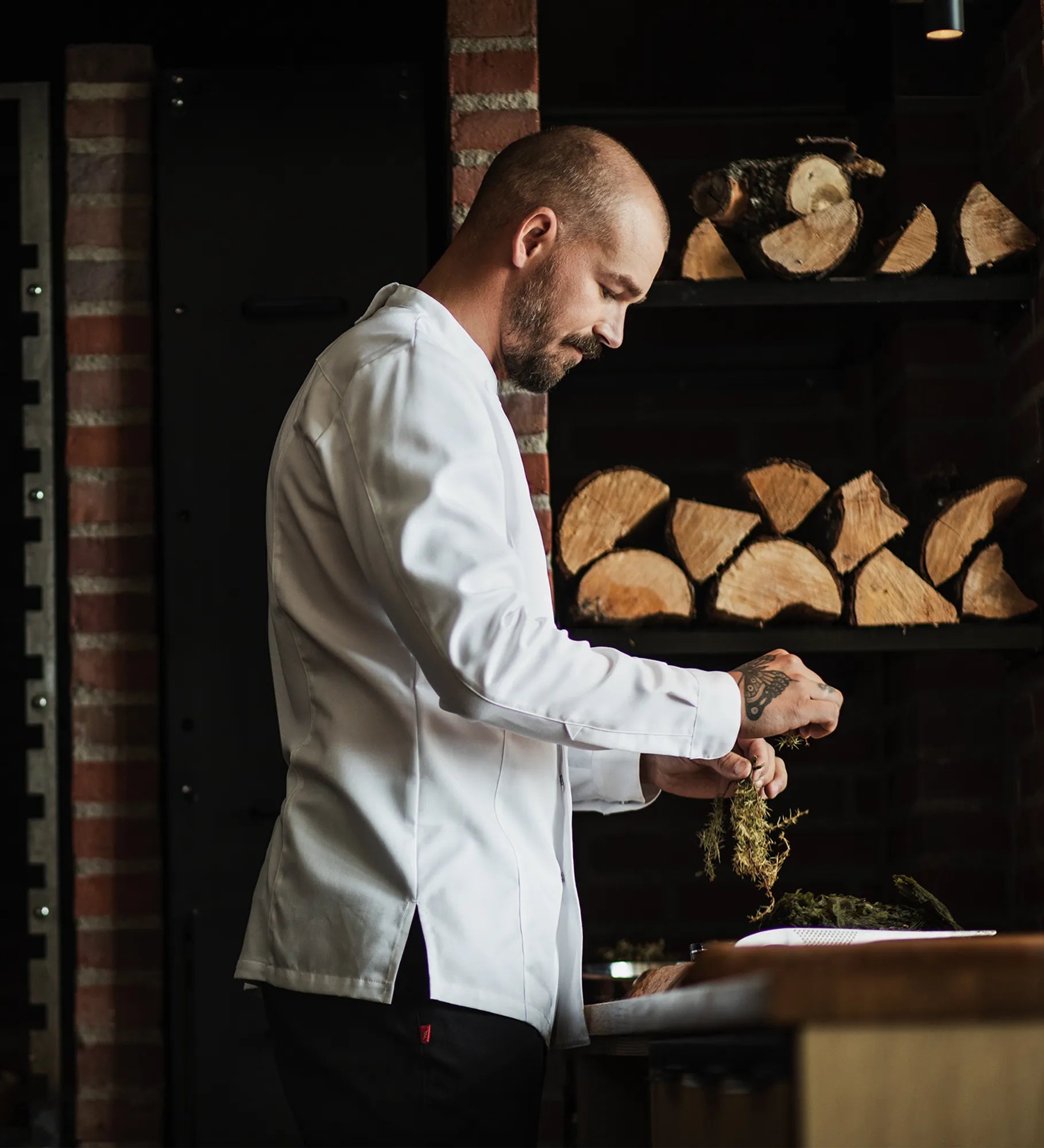Restraint Chef prepping in a long sleeve white chef jacket