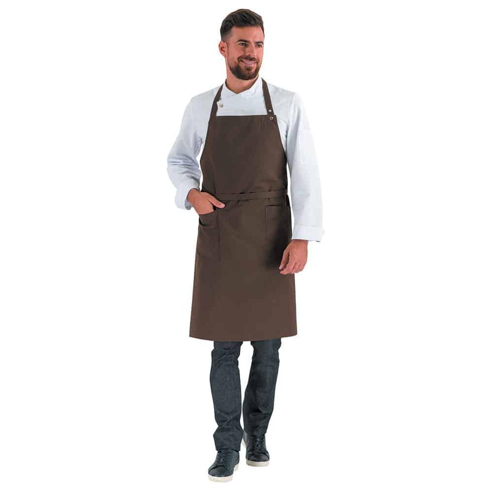 Man wearing a navy braown bib apron with adjustable neck length and waist ties