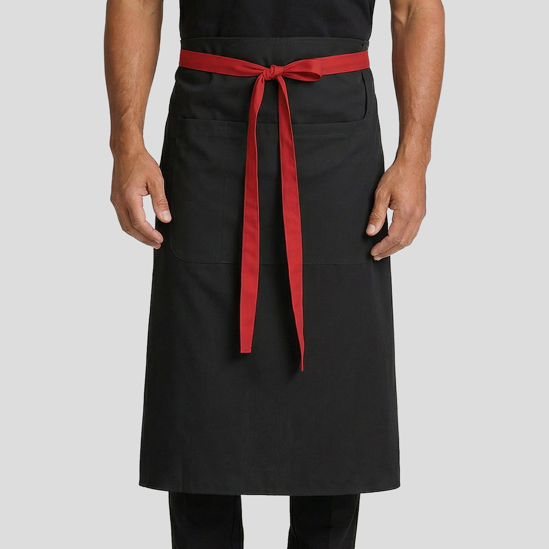 Person wearing a black apron with a red strap on a light gray background