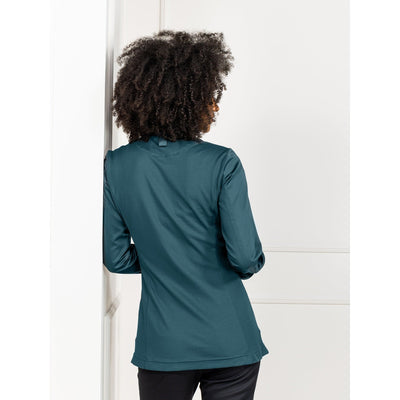 Woman wearing a dark teal color chef's coat with hidden closure, stretch back panel and soft fabric  by Le Nouveau Chef.