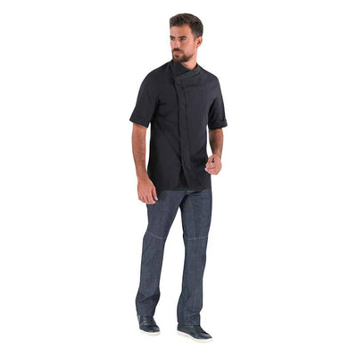 Lafont PARSLEY black, short sleeve men's chef coat, 1/4 view on a kitchen sous chef, professional kitchen uniform.
