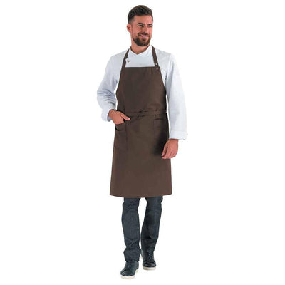Man wearing a navy braown bib apron with adjustable neck length and waist ties