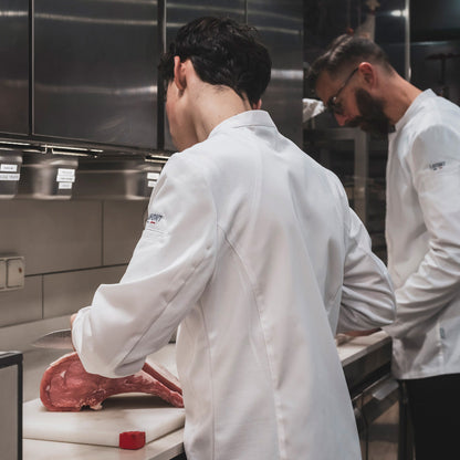 Chefs working in their New York bistro wearing super comfortable white chef coats by Lafont.