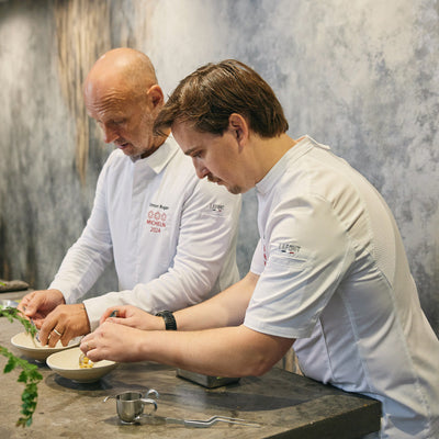 Culinary team, preparing food in non-typical white chef coats 