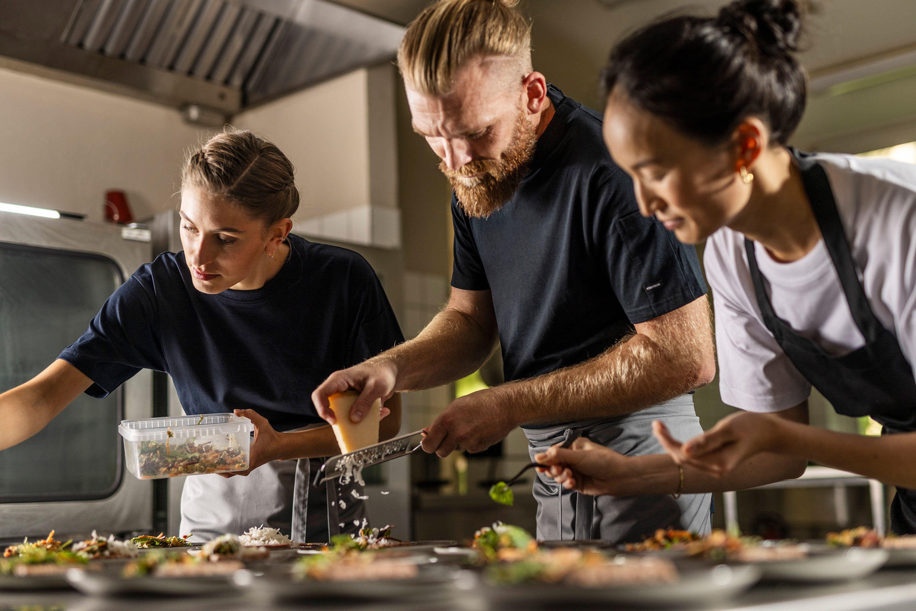 Top chefs prepare meals wearing an array of aprons, shirts,and chef coats
