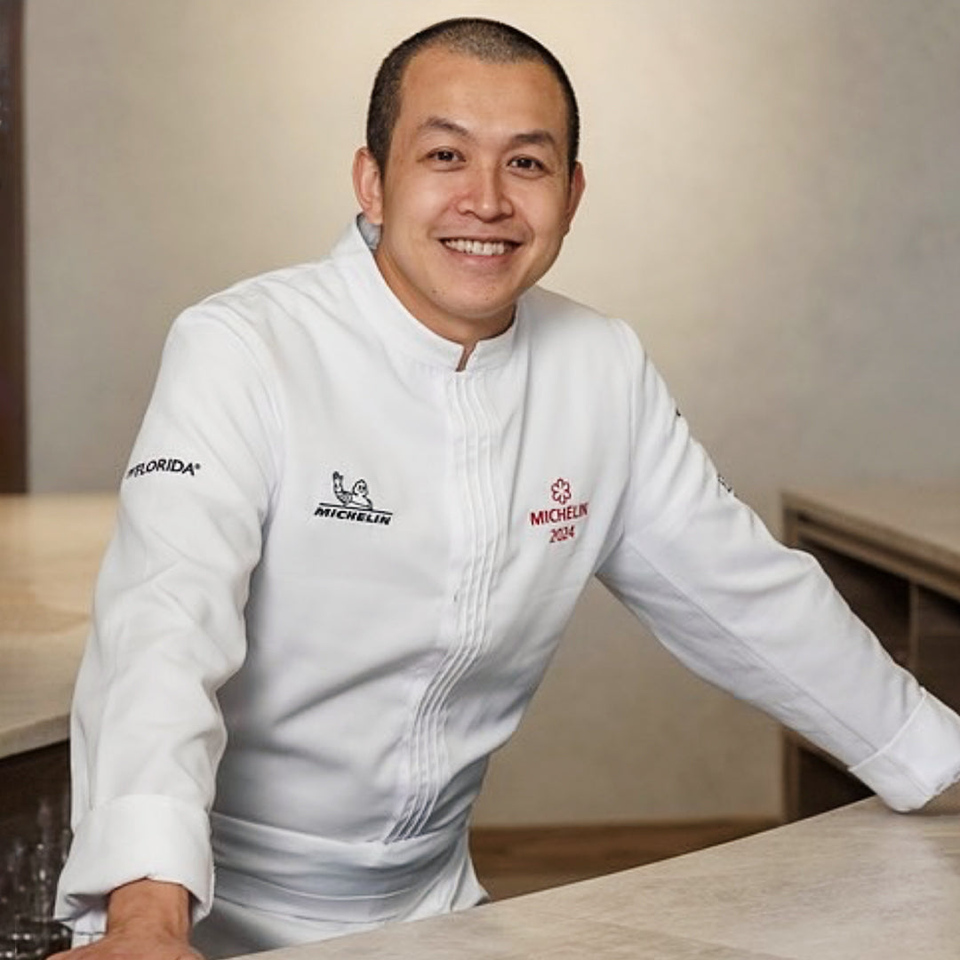 Professional chef wearing white European chef coat in restaurant kitchen