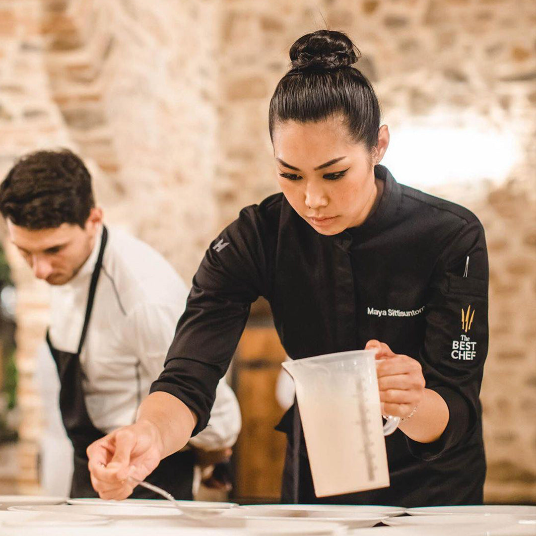 Le Nouveau Chef modern executive chef coat, one is white with long sleeves and another women's chef jacket is black with long sleeves. 