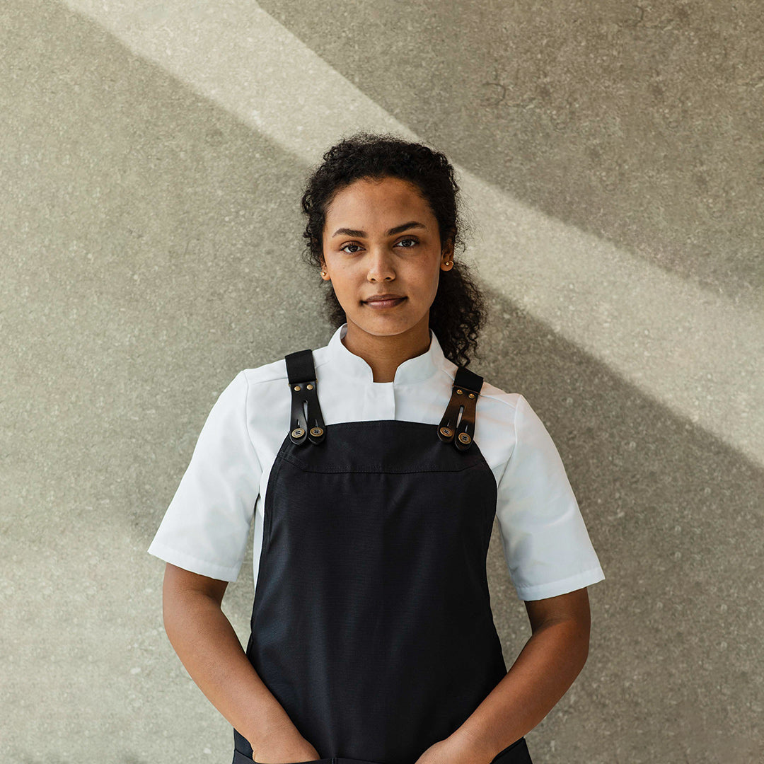Chef standing in an apron from Segers, utilitarian durable and modern fashionable design.